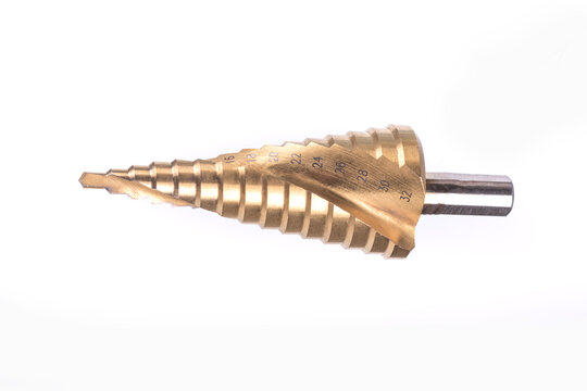 on a white background. multi-stage drill bit of yellow color. close-up.