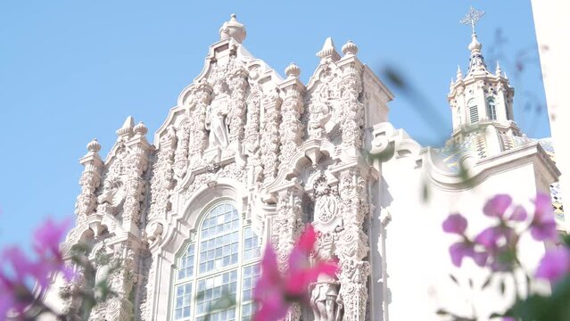 Spanish colonial revival architecture in Balboa Park, San Diego, California USA. Historic building, classic baroque or rococo romance style. Bell tower relief decor and mosaic dome or cupola. Flowers.