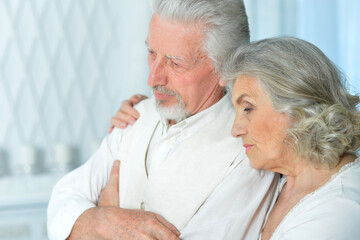 Close-up portrait of sad senior couple posing