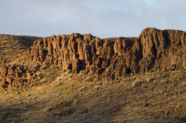 Rocky cliff on a hillside. San Sebastian de La Gomera. La Gomera. Canary Islands. Spain.