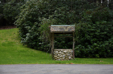 Rustic Wood and Stone Wishing Well on a Farm