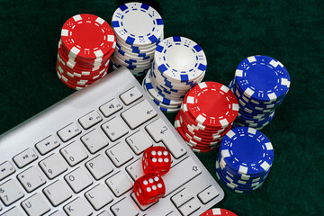 Gambling online casino Internet betting concept. Jackpot, casino chips. computer keyboard, laptop with poker chips, dice. Casino tokens, gaming chips, checks, or cheques