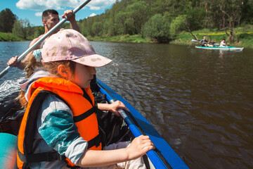 Family kayak trip. Father and daughter, and elderly couple senior and seniora rowing boat on the...