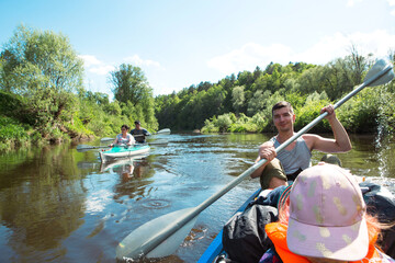 Family kayak trip. Father and daughter, and elderly couple senior and seniora rowing boat on the...