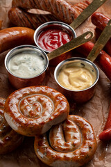 Round fried sausages with ketchup on paper. Bavarian grilled sausages