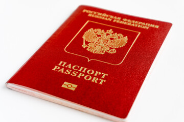 The Russian international passport in red cover. Isolated on white background. Close-up side view.