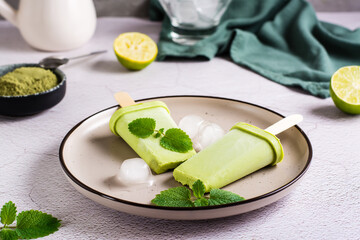 Vegetarian popsicle made from matcha tea, coconut milk and mint on a plate