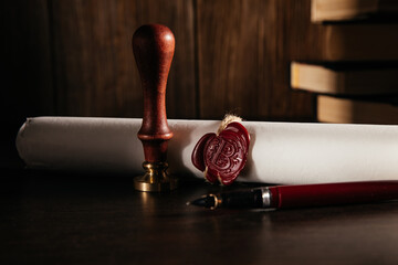 Notary's public pen and document with wax stamp at wooden desk