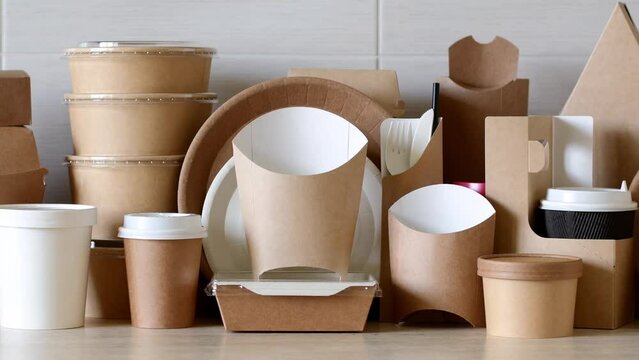 Paper eco-friendly disposable tableware. A large set of dishes and packaging for fast food. Panorama.