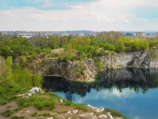 Artificial lake Zakrzowek created in former quarry with picturesque rocks near center of Krakow,...