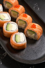 Philadelphia sushi roll with salmon, avocado, cream cheese. Sushi menu. Japanese food