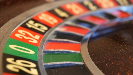 Ball on wooden french roulette table in casino. Wheel spinning, turning or rotating. Odd and even numbers, black, red and zero sectors. Bets in game of chance. Money playing, gambling or risky betting