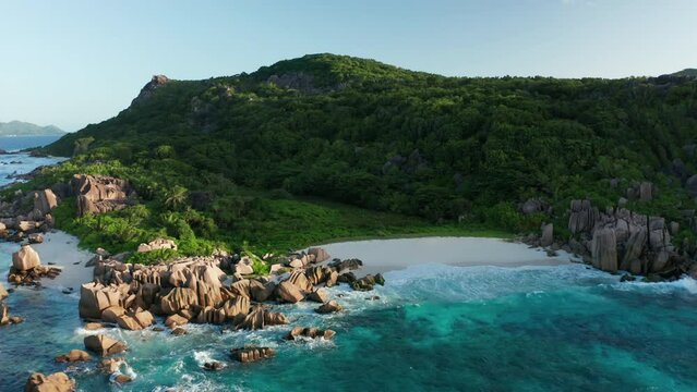 Aerial lock down over amazing solitary Anse Marron beach, La Digue
