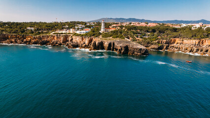 Fototapeta premium Aerial drone view of Farol da Guia in Cascais, Portugal on a sunny day