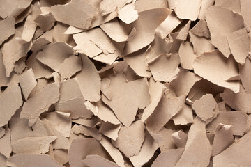 Waste paper as background texture. Recycling brown cardboard heap