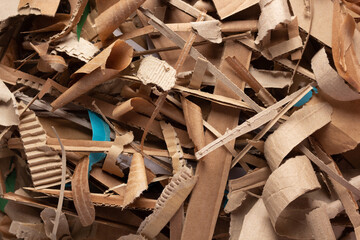 Waste paper as background texture. Recycling brown cardboard heap