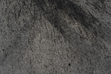 Asphalt texture with white line and tire marks. Smooth asphalt road. Tarmac dark grey grainy road background.Top view - 502097768