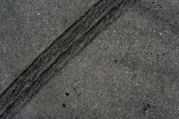 Asphalt texture with white line and tire marks. Smooth asphalt road. Tarmac dark grey grainy road background.Top view - 502098118
