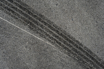 Asphalt texture with white line and tire marks. Smooth asphalt road. Tarmac dark grey grainy road background.Top view - 502098529