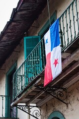 Panama flag hanging from a balcony in the old town of Panama City called casco viejo creatung a scene of a national symbol and pride
