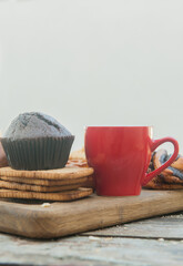 Empty space template with chocolate muffin and red cup of coffee