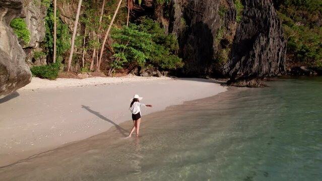 Drone Of Woman Walking Along Tide On Entalula Beach