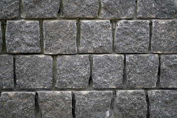 Gray stone wall. Square bricks fence. Abstract pattern of stone mosaic. Taupe Stone wall background texture.