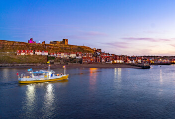 Whitby Harbour at twilight with boat.