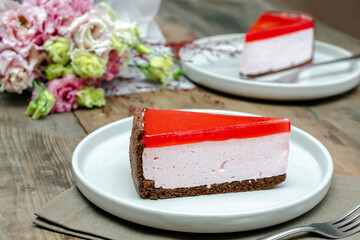 red jelly cheesecake, sweet dessert with flowers bouquet on wooden table background. gift to woman on March 8 holiday, valentine's day breakfast food, international Women's Day