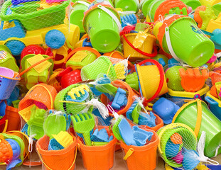 Children's plastic toys. New toy bucket, blade, rake, cars in the store. Sale of children's products