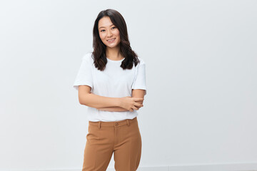 Lovely pretty happy joyful cute Asian young female in white basic t-shirt smiling at camera posing isolated on over white studio background. The best offer for ad. People Lifestyle concept