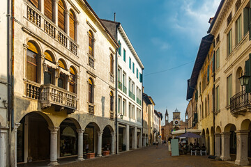 Fototapeta na wymiar View of typical old town street in historical center of Pordenone in sunny autumn day, Italy