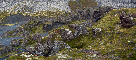 View during auto trip in West Iceland highlands, Snaefellsnes peninsula, Snaefellsjokull National Park, view from spectacular Djupalonssandur black volcanic beach with lava rocks.