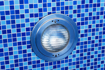 Blue swimming pool with underwater round led light. Pool without water.