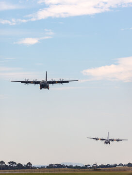 Avalon, Australia - February 27, 2015: Two Royal Australian Air Force Lockheed Martin C-130J Hercules military cargo aircraft performing a tactical approach to Avalon Airport.
