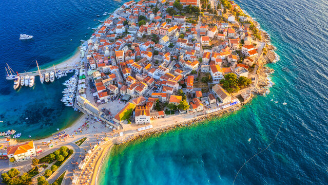 Primosten town, Croatia. View of the city from the air. Seascape with beach and old town. View from drone on the peninsula with houses. Travel and vacation image