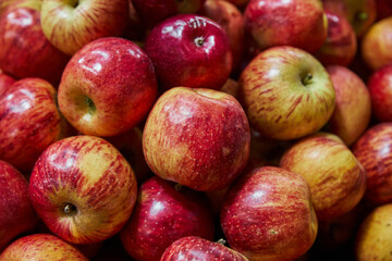 Stacked apples placed on a shelf for sale within a market