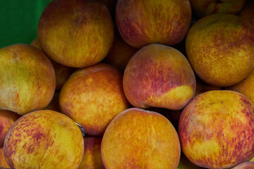 Stacked peaches placed on a shelf for sale at a market