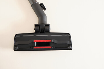 Head of modern vacuum cleaner on beige background. Close up.