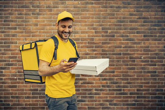 Young Man As A Courier Delivering Food