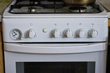 part of one white metal gas stove in the room in the kitchen
