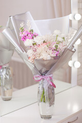 Bouquet of beautiful flowers, peonies and roses on table