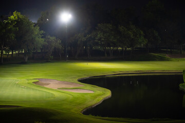 Beautiful dark night view of the golf course, Bunkers sand and green grass, garden background In...