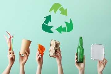 Hands with garbage and symbol of recycling on color background - obrazy, fototapety, plakaty