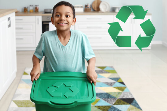 Little African-American boy and container with trash in kitchen. Concept of recycling