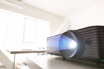 Naklejka premium Video projector on table in conference hall