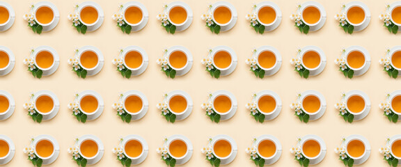 Many cups of jasmine tea on light background, top view. Pattern for design