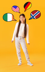 Portrait of cute little girl and speech bubbles with different flags on orange background
