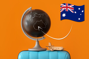 Globe, toy airplane, suitcase and flag of Australia on orange background. Travel concept