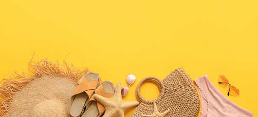 Set of stylish beach accessories on yellow background with space for text
